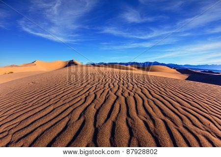 Thin waves on sand. Bright solar morning in picturesque part of Death Valley, USA. Mesquite Flat Sand Dunes, Stovepipe Wells Village