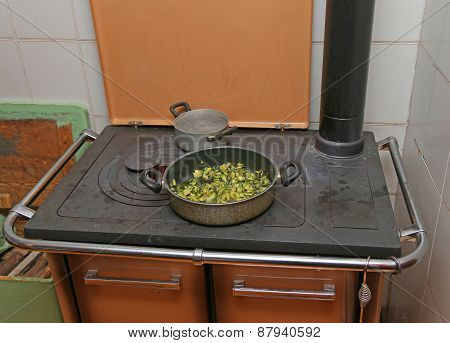 Pan With Zucchini Baked In Cast Iron Stove With Fire Lit