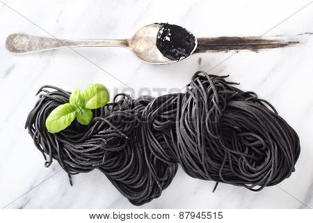 Squid ink homemade pasta on marble