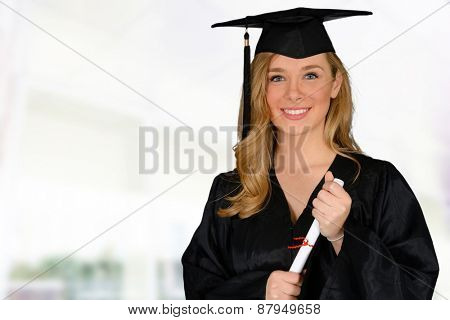 Young successful woman graduating from college holding a diploma