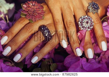 bright colorfull shot of african tanned hands with manicure amon