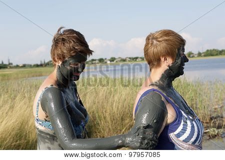 Woman Applying Clay On Her Mother Arm