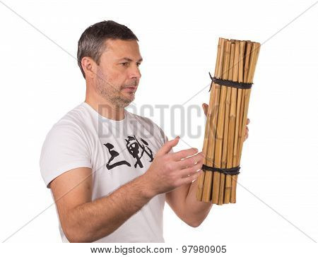 Man throw bunch of bamboo.