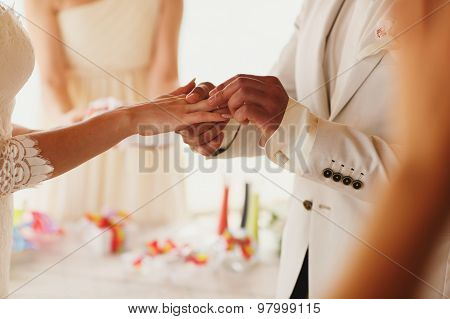 Beautiful  Gorgeous Blonde Bride With Orchids And Stylish Groom Putting On Rings, Hawaii