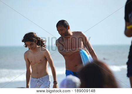 Nice talk on the beach between father and son