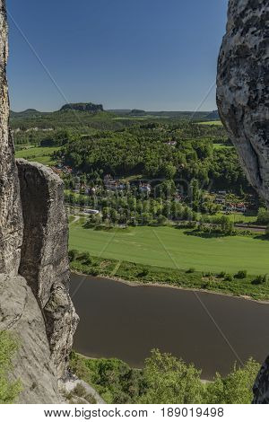 Big rocks near Bastei bridge in valley of river Elbe or Labe in spring sunny day