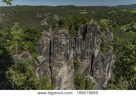 Big rocks near Bastei bridge in valley of river Elbe or Labe in spring sunny day