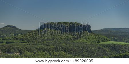 Big rocks near Bastei bridge in valley of river Elbe or Labe in spring sunny day