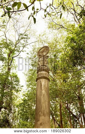 Asoka concrete pillar under tree shade Budhism symbolic and believe