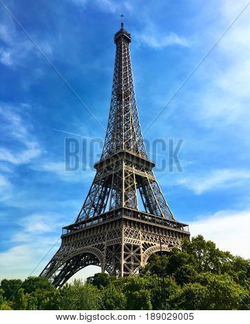 The iconic Eiffel Tower against a bright blue sky