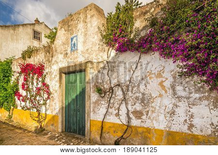 OBIDOS,PORTUGAL - MAY 11,2017 - In the streets of the picturesque town of Obidos. The area of the town of Obidos is located on a hilltop encircled by a fortified wall.