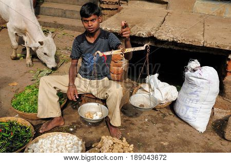 PURI INDIA - 17 DECEMBER 2009: Street vendor selling vegetables on the streets in the old town in Puri Puri in December 17 2010