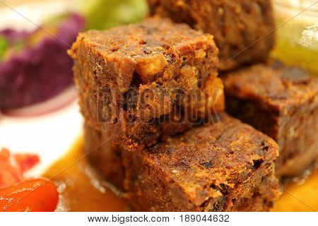Closed up crispy deep fried minced pork cubes with spicy sauce, with selective focus