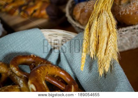 Ears of wheat and pretzel breads at counter in bakery shop