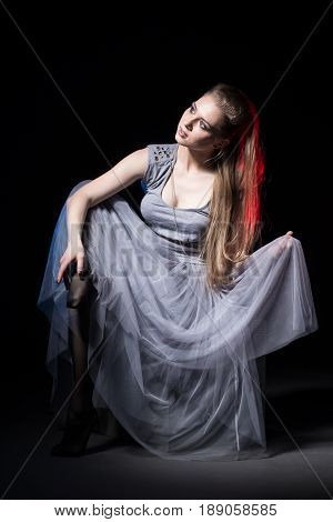 Actress In A Grey Dress On A Dark Stage