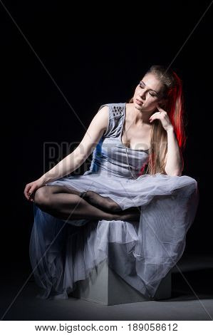 Actress In A Grey Dress On A Dark Stage