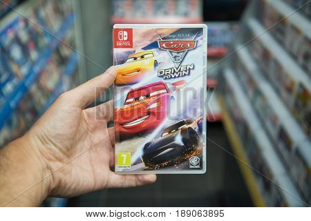 Bratislava, Slovakia, June 1 2017: Man holding Cars 3 Driven To Win videogame on Nintendo Switch console in store