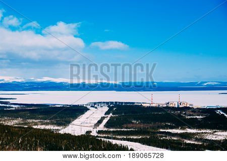 Kola NPP  nuclear power station from the mountain. Industrial landscape. In the background are the mountains of Khibiny and Imandra lake.