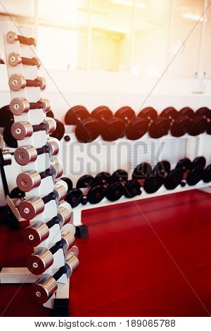 Sports equipment dumbbell rests in a row.  hign contrast and monochrome color tone