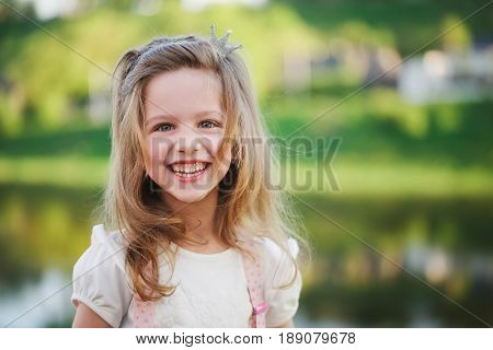 portrait of cute little girl in summer park