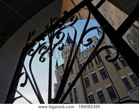 KIEV - UKRAINE - MAY, 2017: View of the Richard Castle on Andreevsky Spusk in Kiev. In the foreground, forged black gates