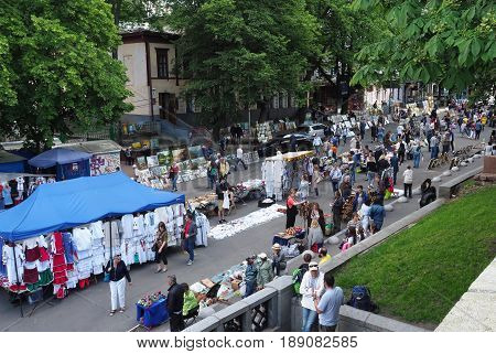 KIEV - UKRAINE - MAY, 2017: Fair on Vladimirskaya street on the Day of Kiev. People walk around the tents with Ukrainian souvenirs. Street lined with paving stones, chestnuts - a symbol of Kiev