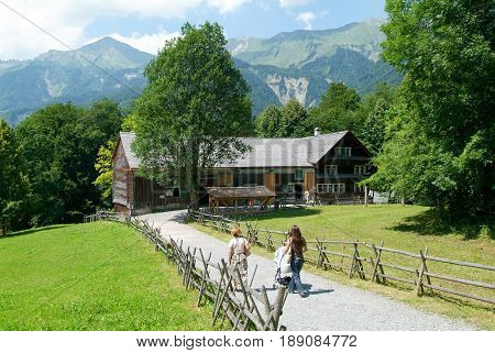 Ballenberg Switzerland - 14 July 2005: People visiting on walking old farm house in Ballenberg a Swiss open-air museum in Brienz Switzerland