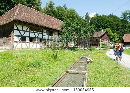 People Visiting On Walking Old Farm Houses In Ballenberg