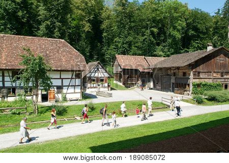 People Visiting On Walking Old Farm Houses In Ballenberg