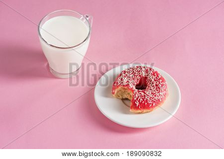 Top View Of Glass Cup Of Milk With Donut On Plate On Pink Background