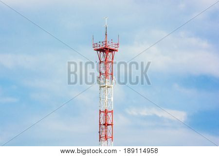 Radio tower against blue sky on sunny day