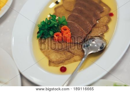 Cold appetizers jelly tongue on the table
