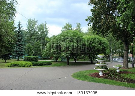Vase decoration in the park, flowerbed, trees landscape