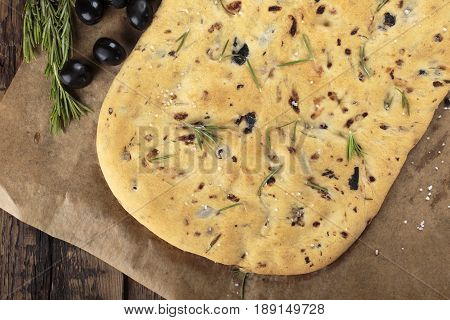 Italian focaccia bread with olives and rosemary. Top view.