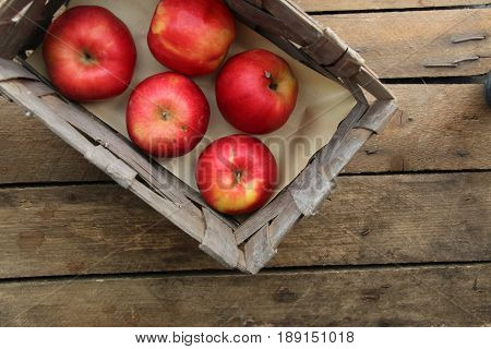 Wooden crate box full of fresh apples on table