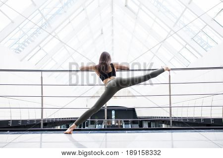 Beautiful Yoga Woman Practice In A Big Business Hall Background. Yoga Concept.