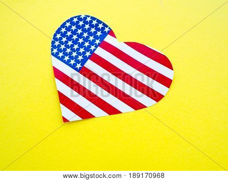 American flag in the shape of a heart on bright yellow background USA independence day