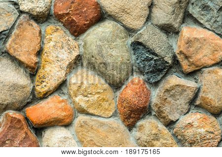 Rubble masonry wall. Stone wall made of various sizes stone can be used as background.