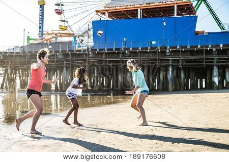 Lesbians mothers with adopted child - Happy homosexual family playing with her daughter