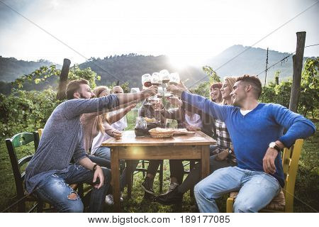 Group of friends at restaurant outdoors - People having dinner in a home garden