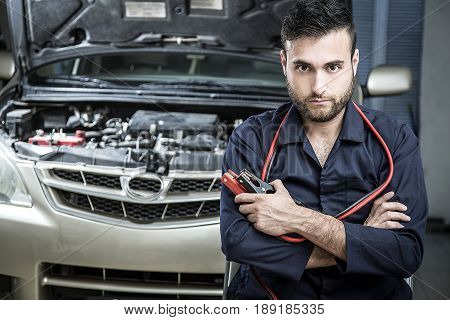Car Mechanic Man At The Garage Fixing The Engine