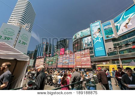 Toronto, Ontario, Canada, Dundas square down town, May 20, 2017, amazing gorgeous inviting view of many people at dundas square, walking, sitting, relaxing and enjoying their weekend time on sunny day