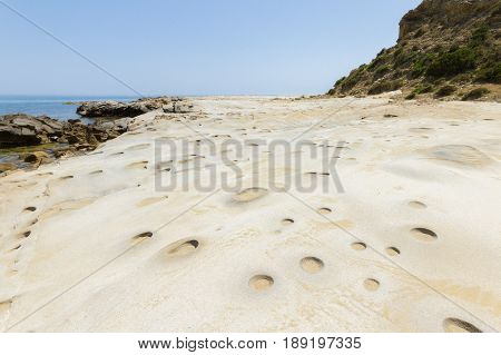Beach Rocks With Craters In Karpasia, Island Of Cyprus