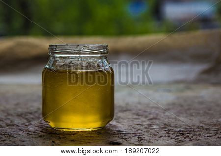 Honey In Jar And Window With Green On Backcground