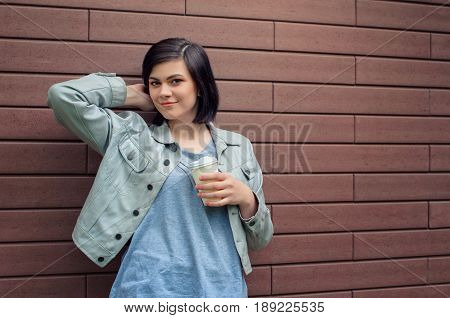 Smiling Brunnete Girl With Tunnels In The Ears In A Beige  Leather Jacket