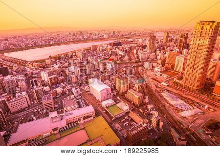 Aerial view of Osaka City Central business and Yodo River with its bridges at sunset colors. Osaka Skyline from Kita ward of Japan.