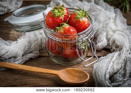 Strawberry In Jar On Wooden Background.