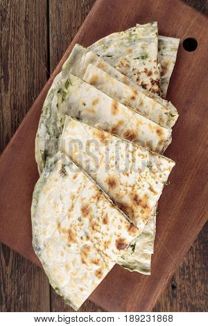Scallion pancakes. Round unleavened flatbread minced green onions. Top view.