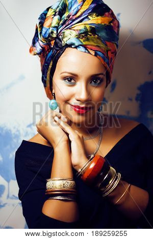 beauty bright real african woman with creative make up, shawl on head like cubian closeup smiling