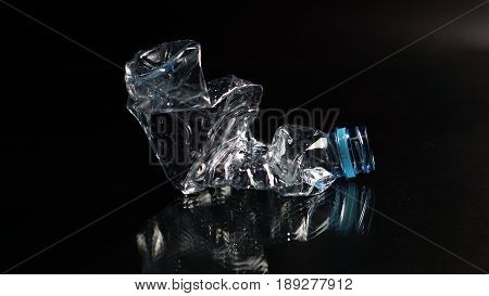 Plastic bottle on black mirror, the garbage can recycle.
